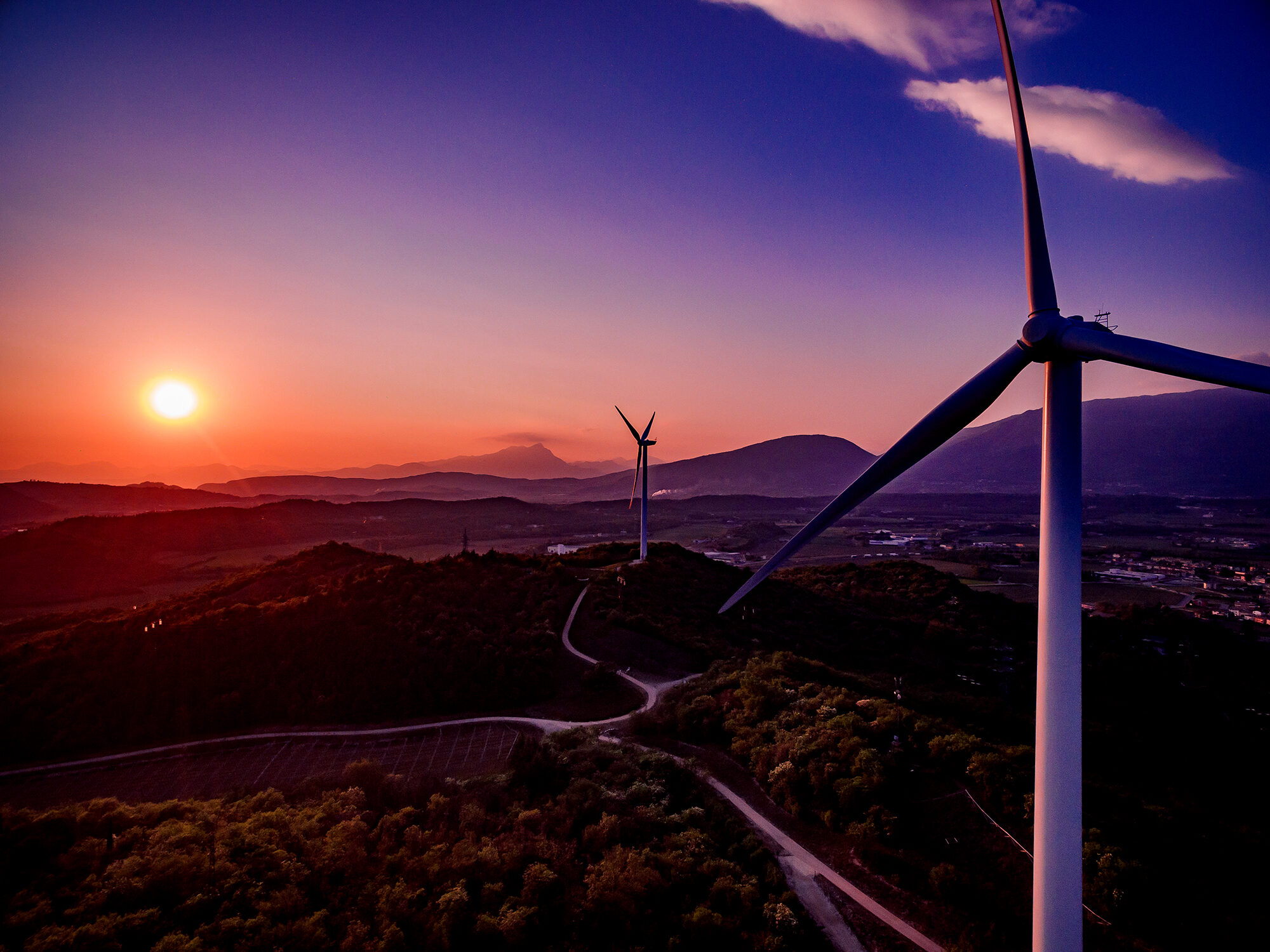 Wind Turbines Windmill Energy Farm at sunset in Italy